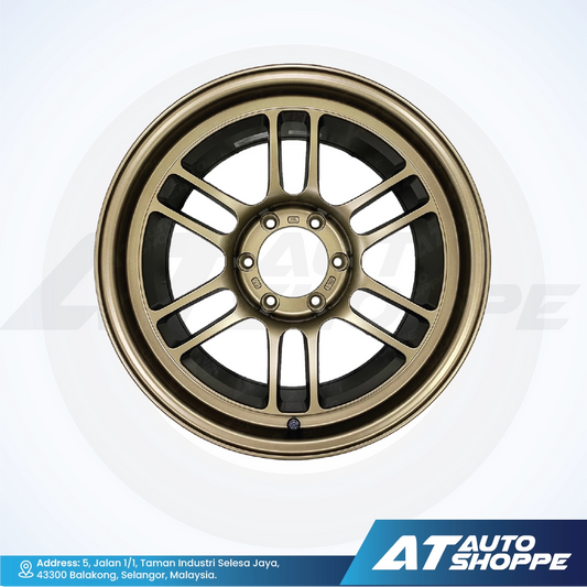 Gold alloy wheel on a white background with AT Auto Shoppe branding.