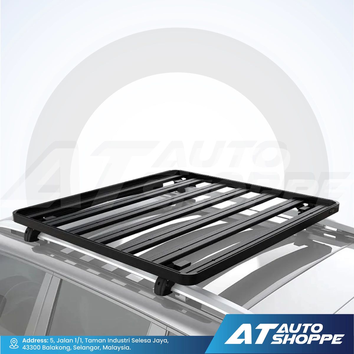 Black roof rack on a car with AT Auto Shoppe branding.