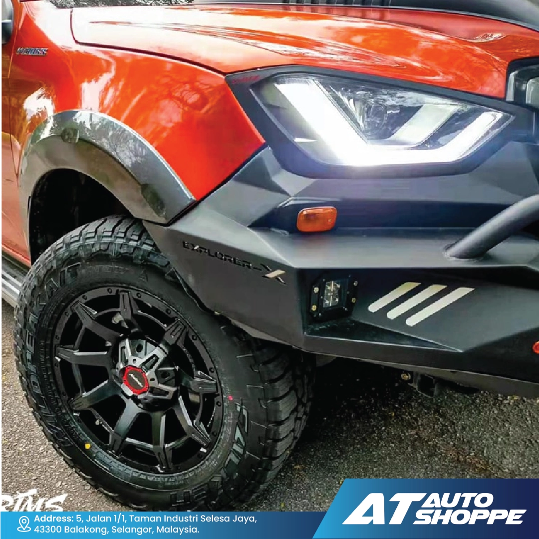 Close-up of a red SUV withMonsterims wheel and visible branding at AT Auto Shoppe.