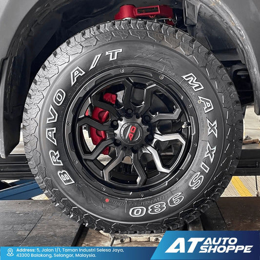 Close-up of a tire with 'Bridgestone' branding on a vehicle, featuring red brake calipers.
