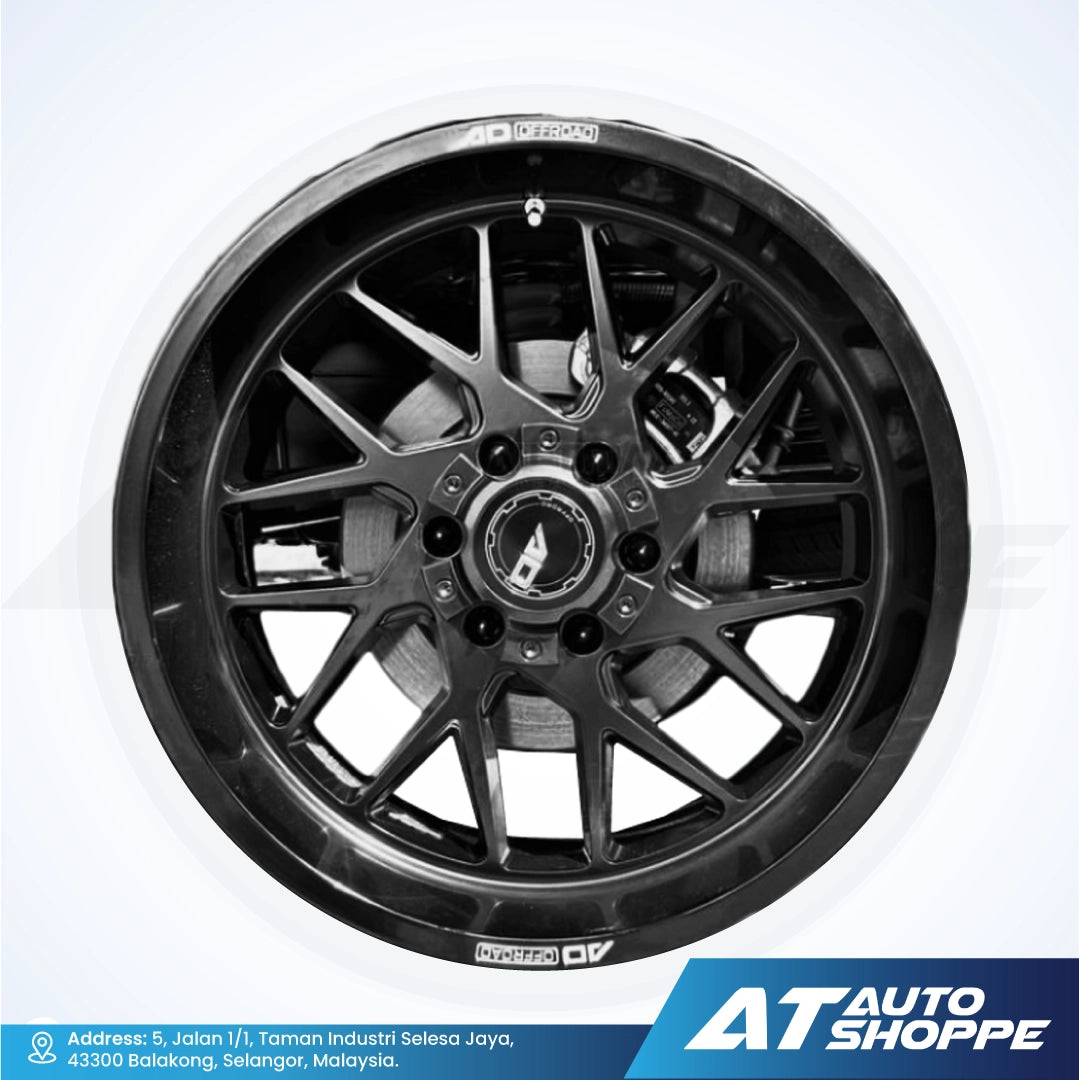 Car wheel rim with a white background and AT Auto Shoppe branding.