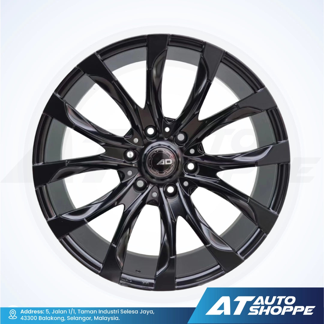 Black alloy wheel with 'AD' branding on a white background, featuring AT Auto Shoppe logo.