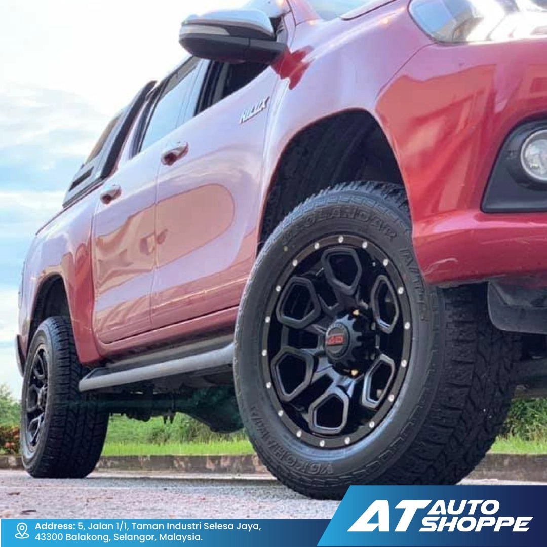 Close-up of a red SUV with black wheels on a road, featuring AT Auto Shoppe branding and AD Wheels.
