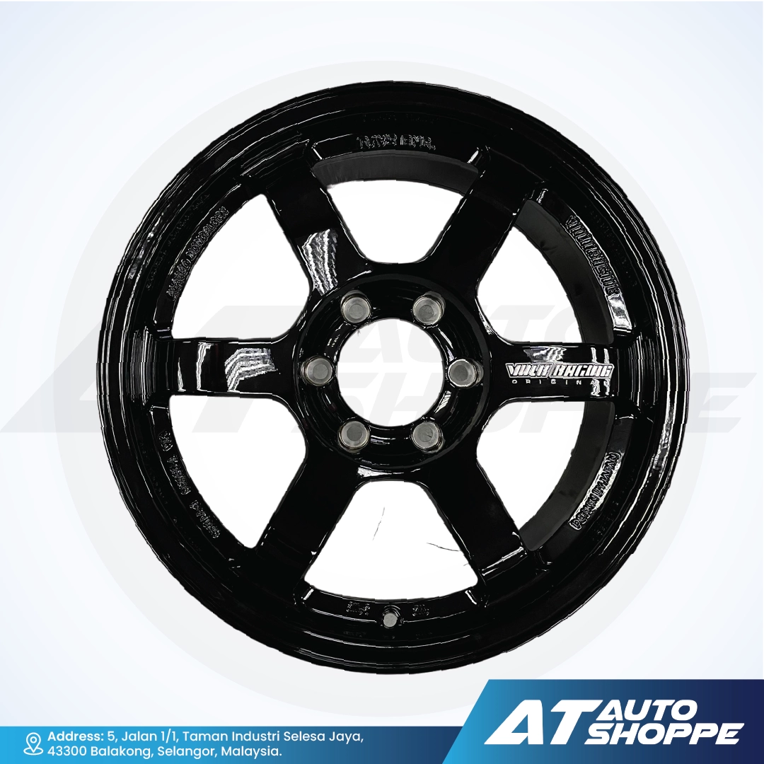 Black alloy wheel on a white background with AT Auto Shoppe branding.