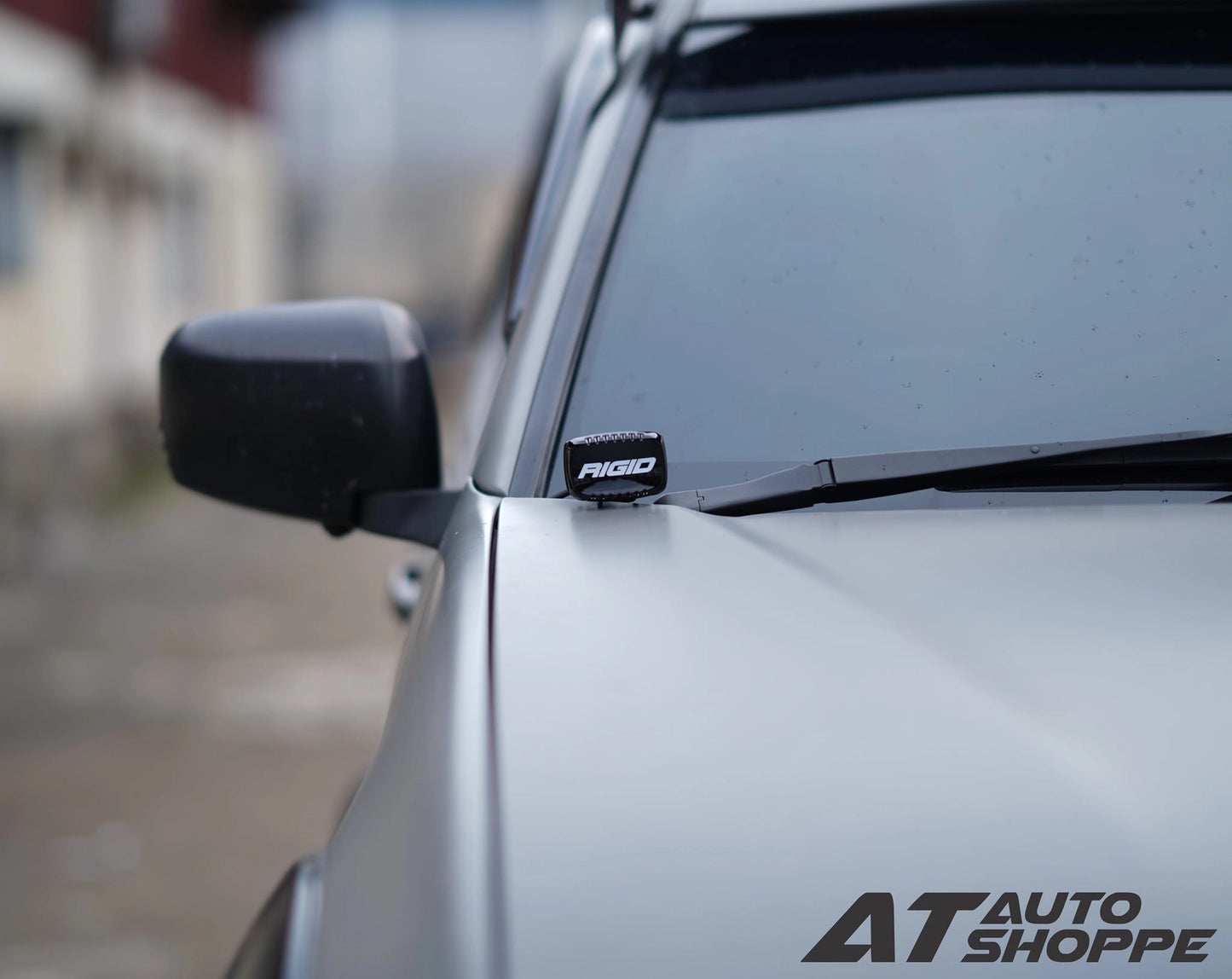 Car with a Rigid Industries light on the windshield, blurred background