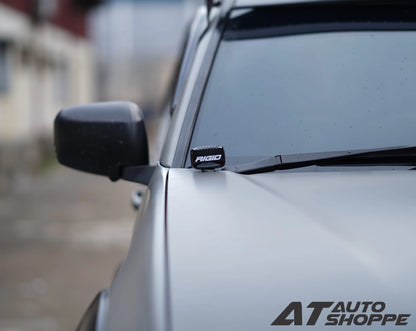 Car with a Rigid Industries light on the windshield, blurred background