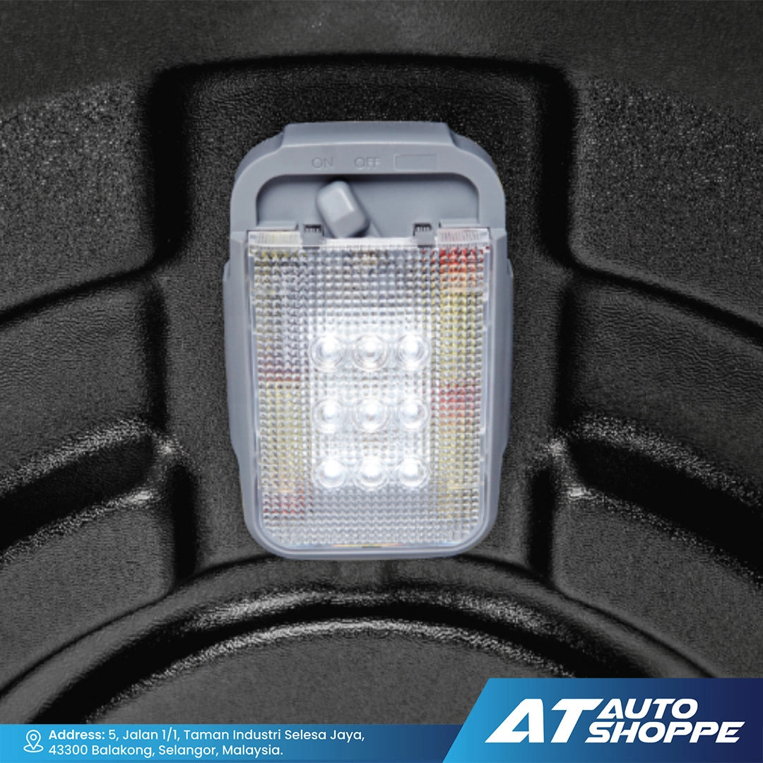 Car license plate light on a black textured background with AT Auto Shoppe branding.
