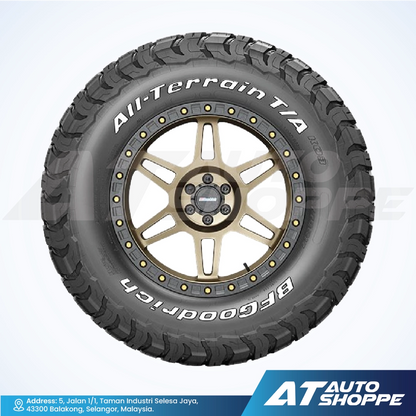 All-terrain BFGoodrich tire with gold rim on a white background, featuring Goodrich branding.