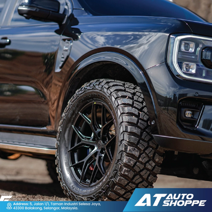 Close-up of a black truck BFGoodrich tire with AT Auto Shoppe branding.