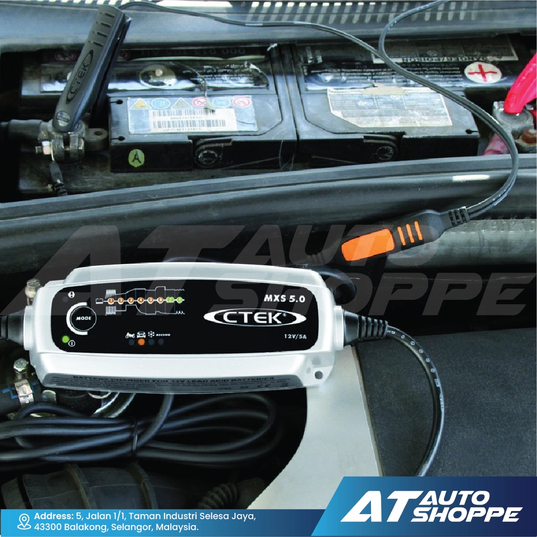 Car battery charger with CTEK branding inside a vehicle, connected to a battery.