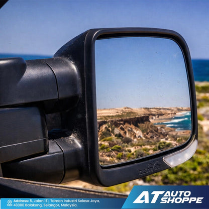 Car side mirror with scenic reflection of ocean and cliffs, AT Auto Shoppe branding visible.