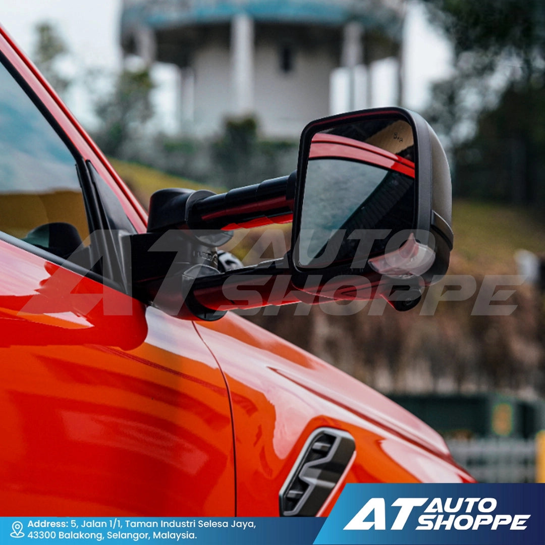 Close-up of a car's side mirror with 'AT Auto Shoppe' branding.