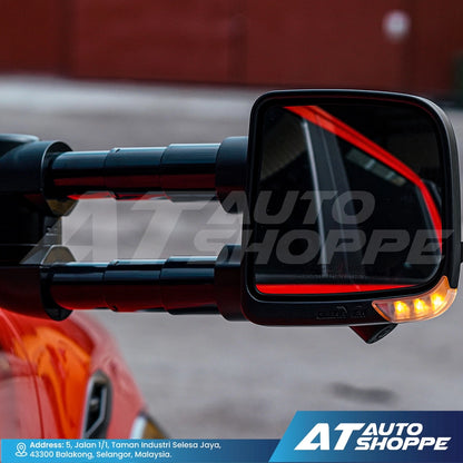 Motorcycle side mirror with turn signal on a blurred background, featuring AT Auto Shoppe branding.