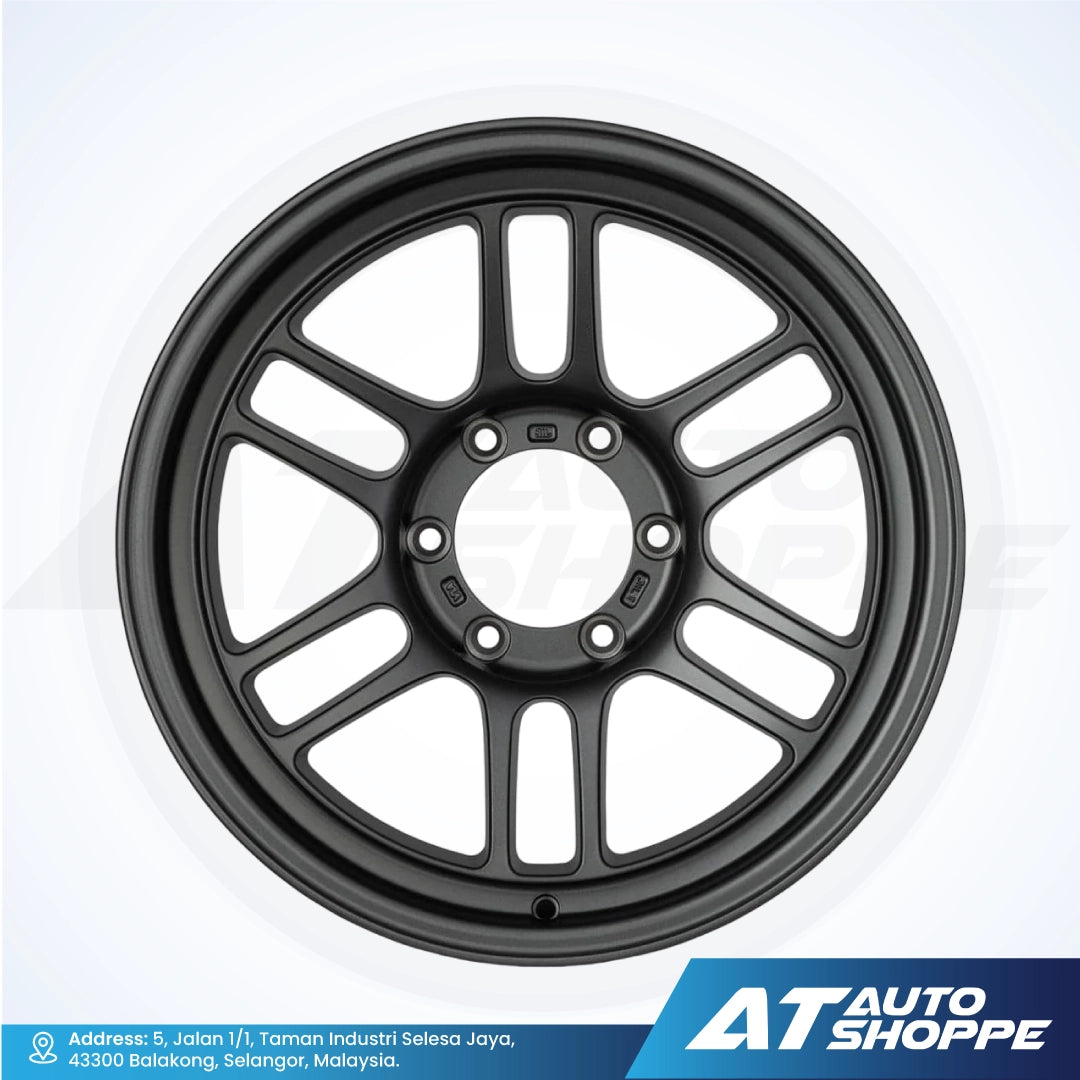 Black alloy wheel on a white background with AT Auto Shoppe branding.