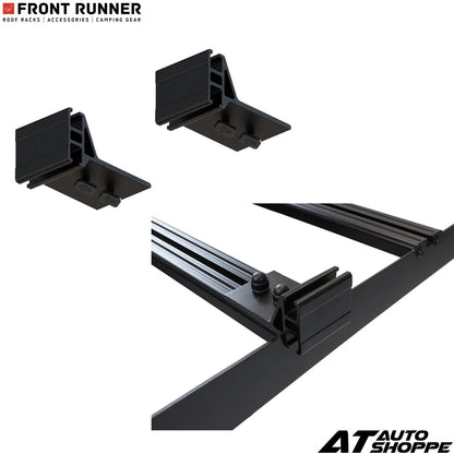 Black roof rack components with 'Front Runner' and 'AT Auto Shoppe' branding on a white background.