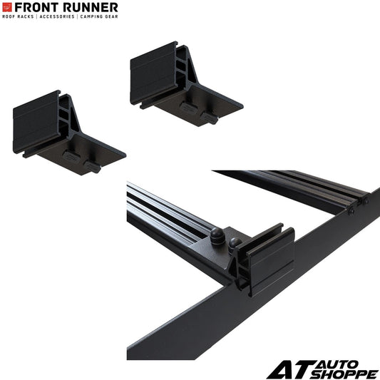 Black roof rack components with 'Front Runner' and 'AT Auto Shoppe' branding on a white background.