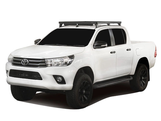 White Toyota truck with a roof rack on a white background