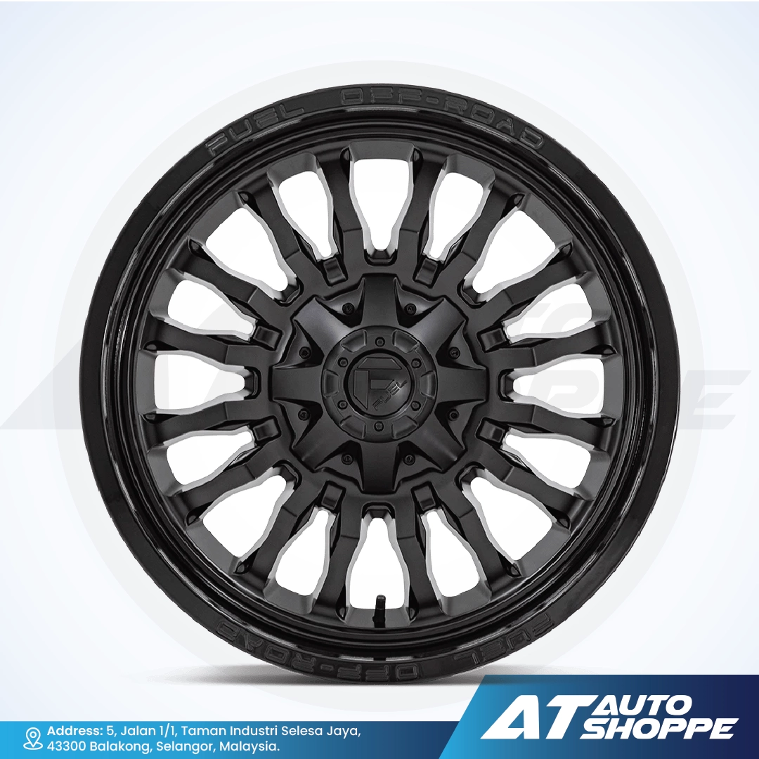 Black alloy wheel on a white background with AT Auto Shoppe branding.