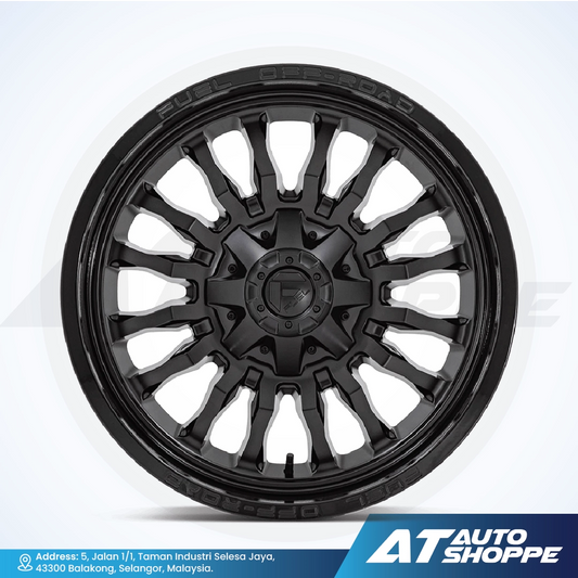 Black alloy wheel on a white background with AT Auto Shoppe branding.