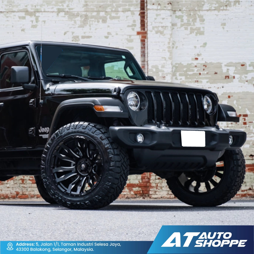 Black Jeep vehicle parked in front of a brick wall with AT Auto Shoppe branding.