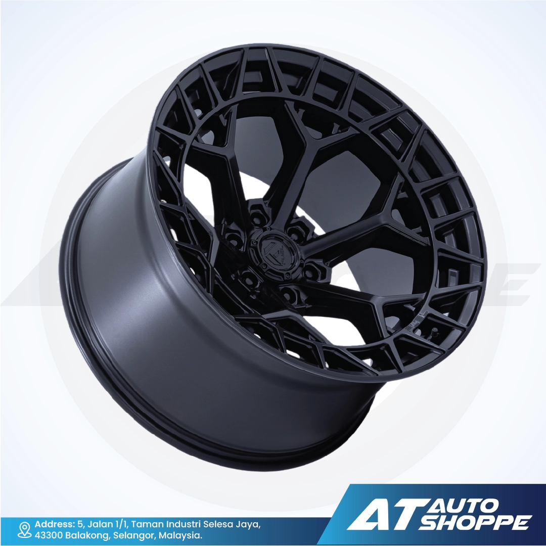 Black alloy wheel on a white background with AT Auto Shoppe branding.