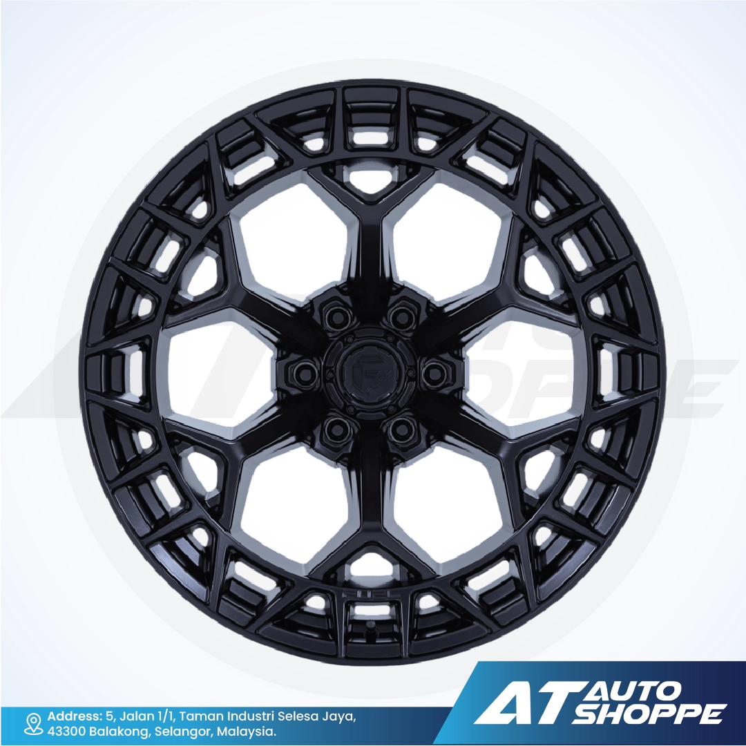 Black alloy wheel rim on a white background with AT Auto Shoppe branding.
