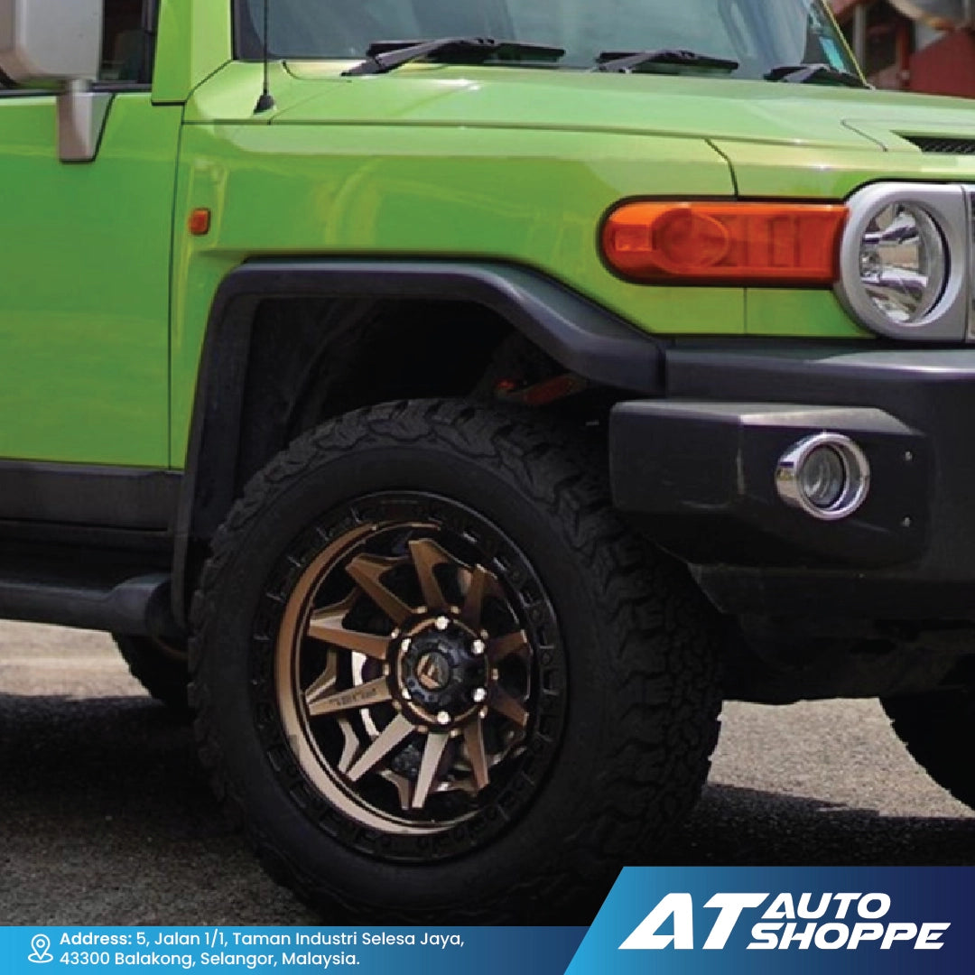 Close-up of a green SUV with a visible brand logo at the bottom.