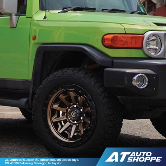 Close-up of a green SUV with a visible brand logo at the bottom.