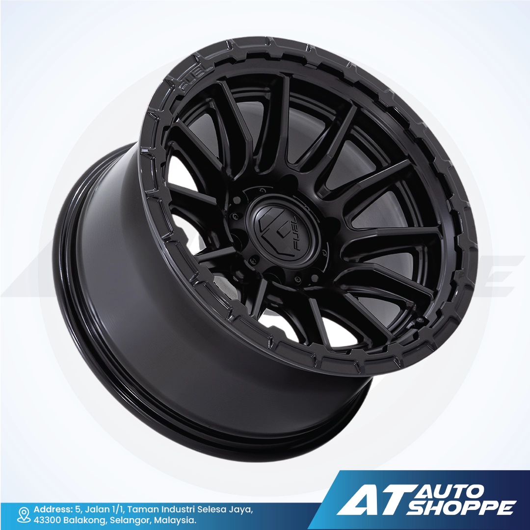 Black alloy wheel on a white background with AT Auto Shoppe branding.