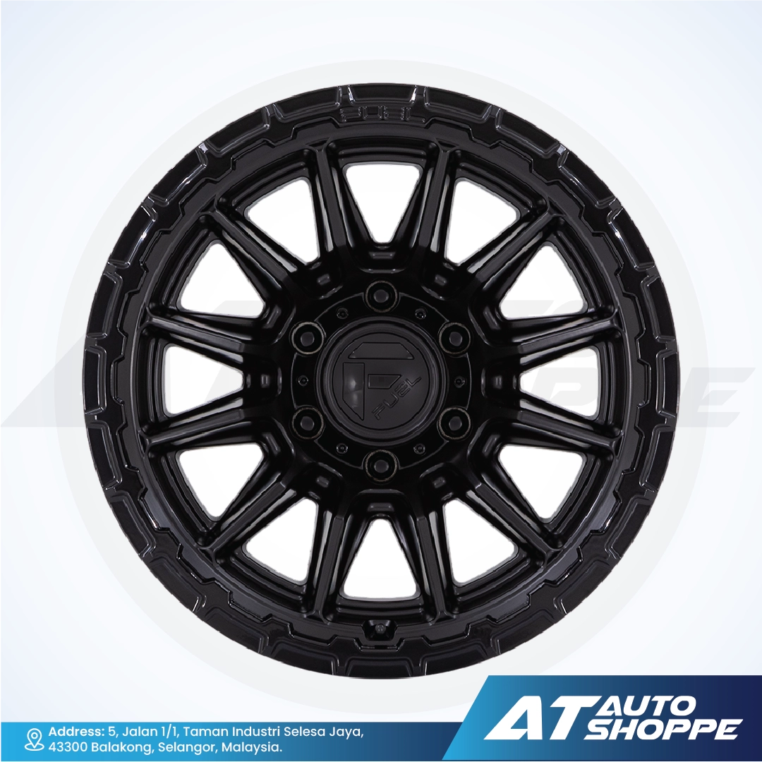 Black alloy wheel on a white background with AT Auto Shoppe branding.