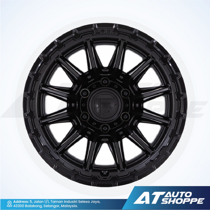Black alloy wheel on a white background with AT Auto Shoppe branding.