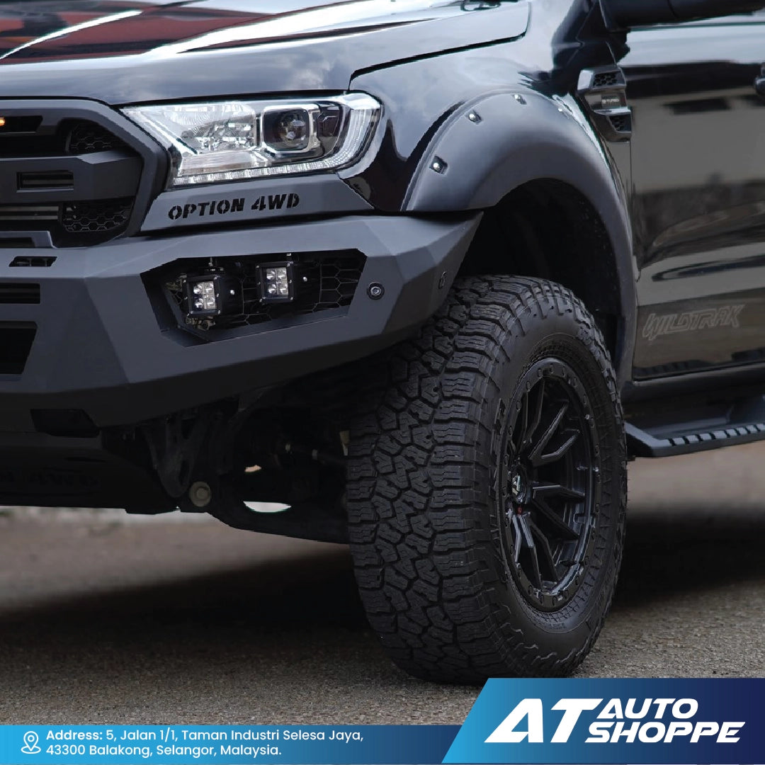 Close-up of a black off-road vehicle with 'Option 4WD' branding, featuring a large tire and detailed front bumper.