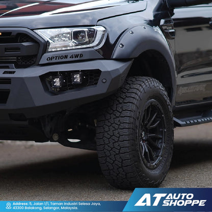 Close-up of a black off-road vehicle with 'Option 4WD' branding, featuring a large tire and detailed front bumper.