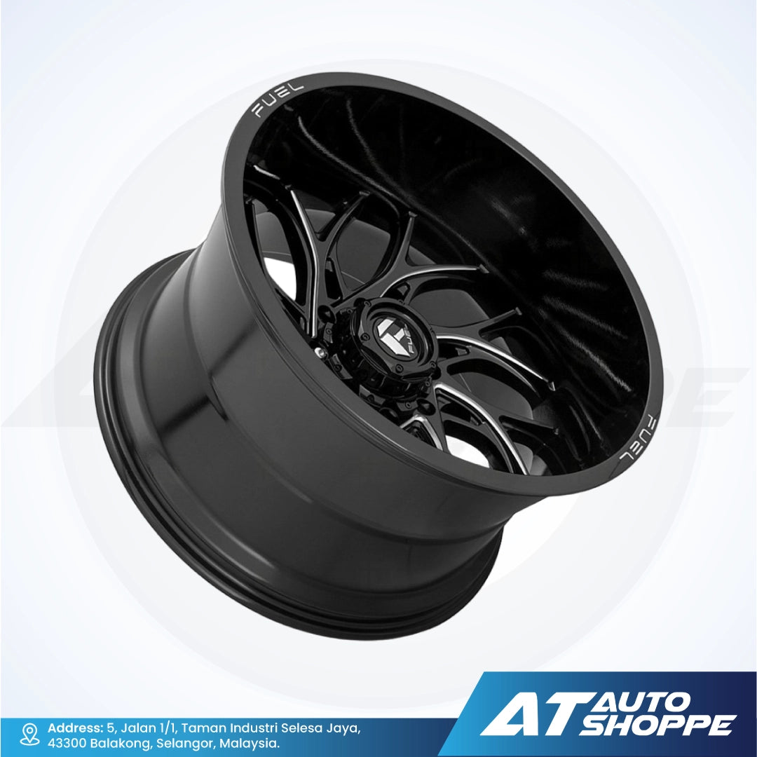 Black alloy wheel on a white background with AT Auto Shoppe branding.