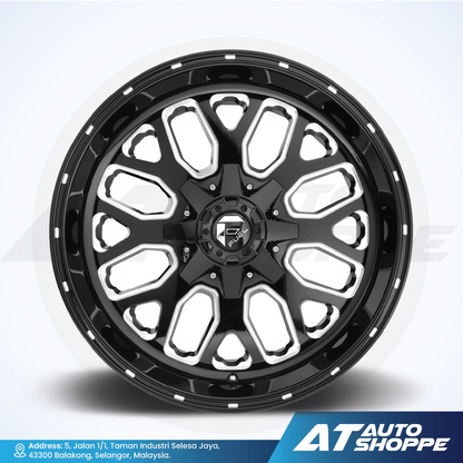 Black alloy wheel with a white rim on a light gray background, featuring the AT Auto Shoppe logo.