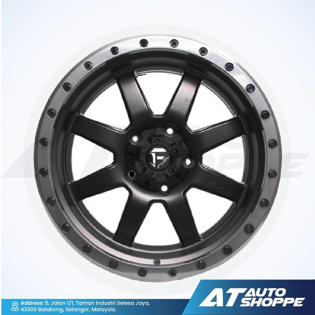 Car wheel rim with metallic finish on a white background, featuring AT Auto Shoppe branding.