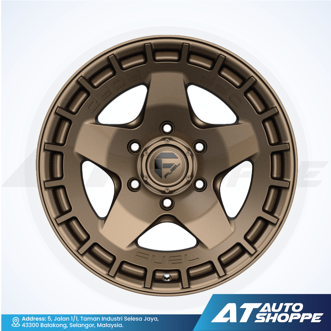 Bronze alloy wheel with star design on a white background, featuring AT Auto Shoppe branding.