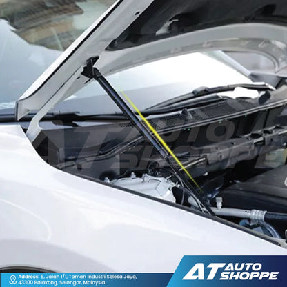 Car hood open with GT Pro strut showing engine components, with AT Auto Shoppe branding.