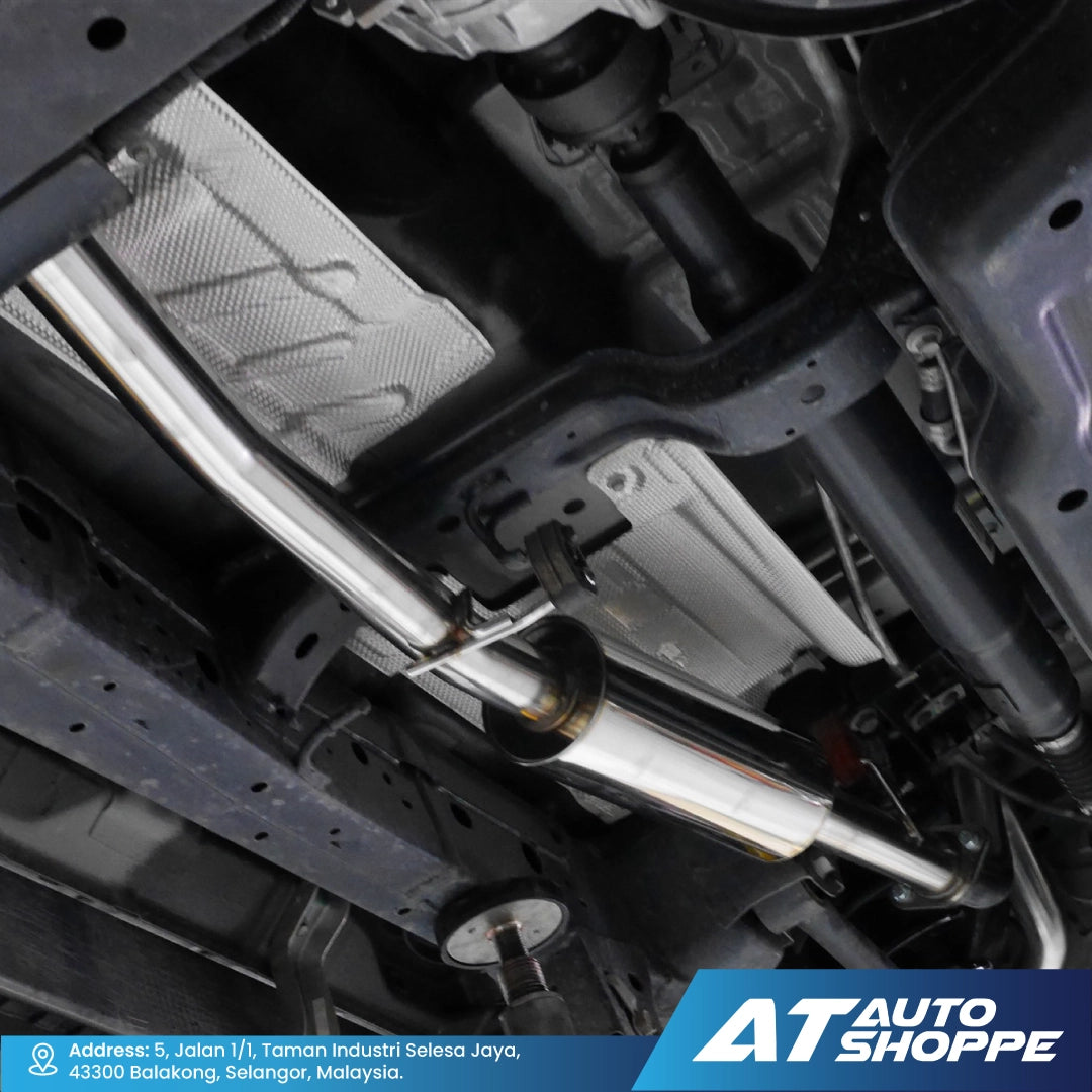 Close-up of a car's undercarriage with visible suspension components and branding at AT Auto Shoppe.