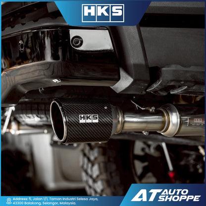 Car exhaust system with HKS branding on a blurred background