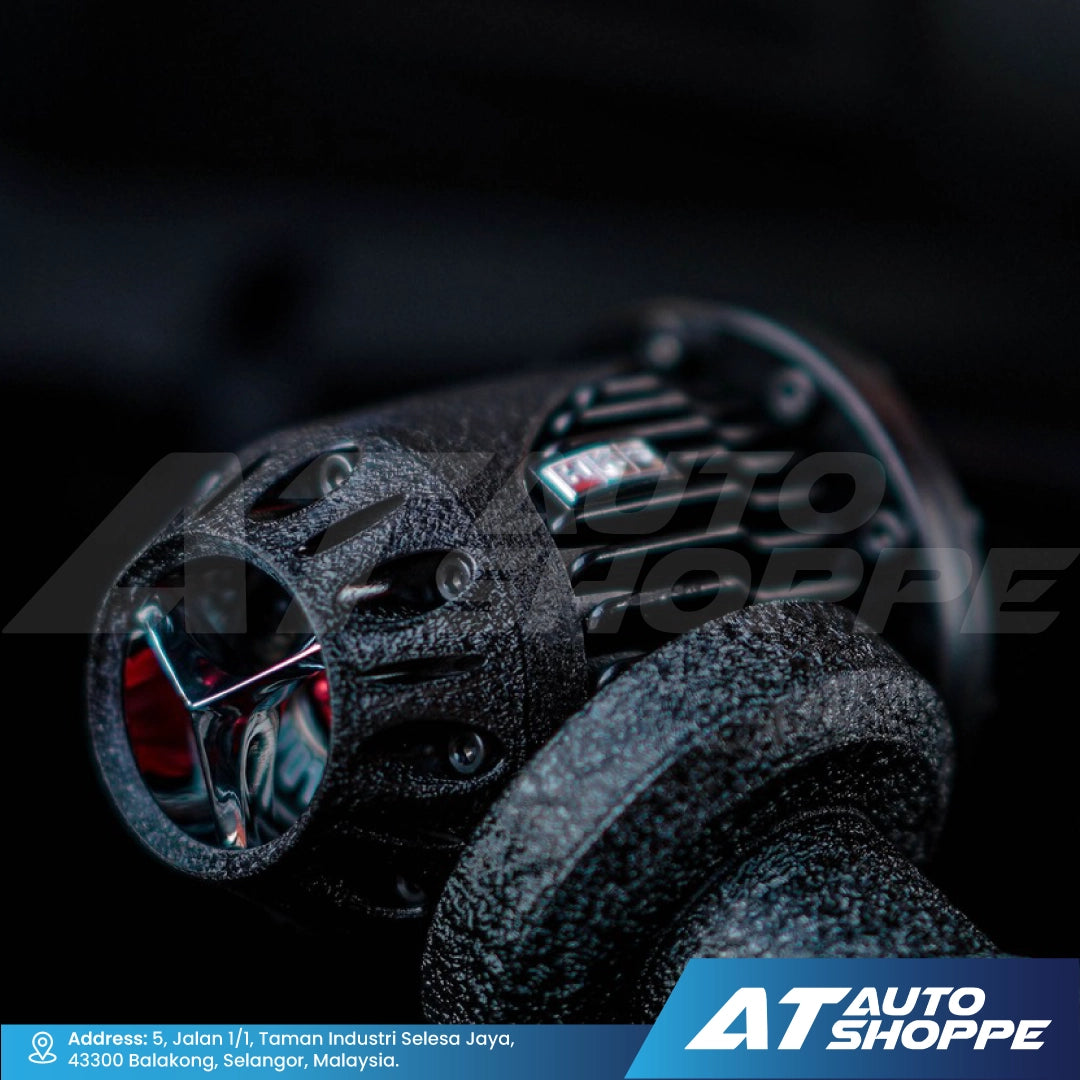 Close-up of a mechanical component with 'AT Auto Shoppe' branding.