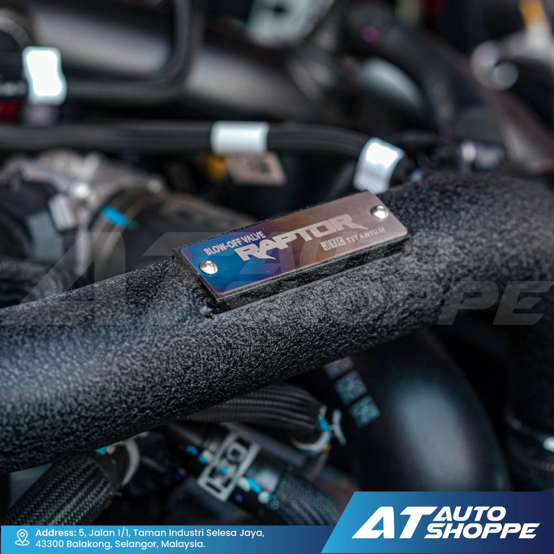 Close-up of a car part with 'Raptor' branding, blurred background