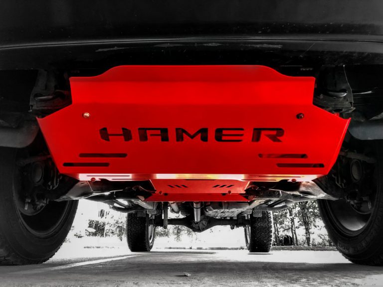 Red undercarriage guard with 'HAMER' branding on a vehicle