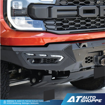 Close-up of a red truck's front grille and bumper with 'AT Auto Shoppe' branding.