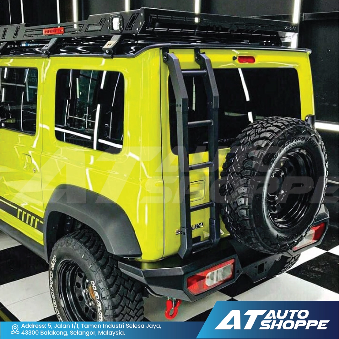 Yellow SUV with roof rack and off-road tires in a showroom setting, featuring AT Auto Shoppe branding.