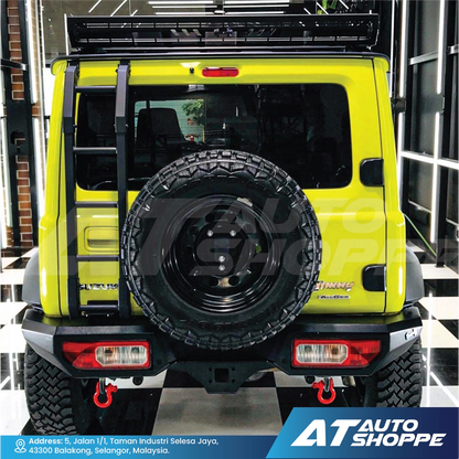 Yellow off-road vehicle with spare tire and AT Auto Shoppe branding.