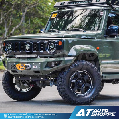 Green SUV with off-road modifications on a road, featuring the AT Auto Shoppe logo.