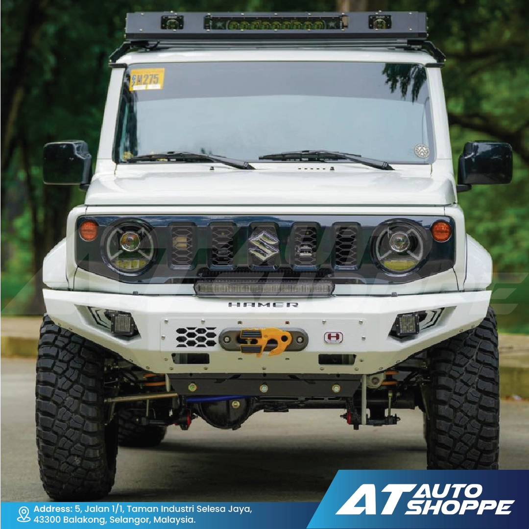 White off-road vehicle with additional lights and a bumper, parked outdoors.