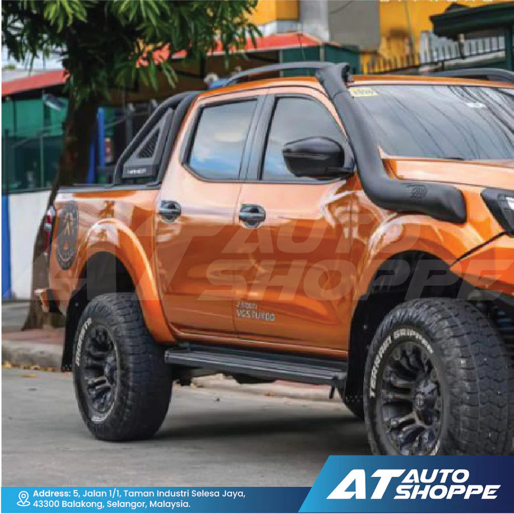 Orange pickup truck with black roof rack on a street, featuring AT Auto Shoppe branding.