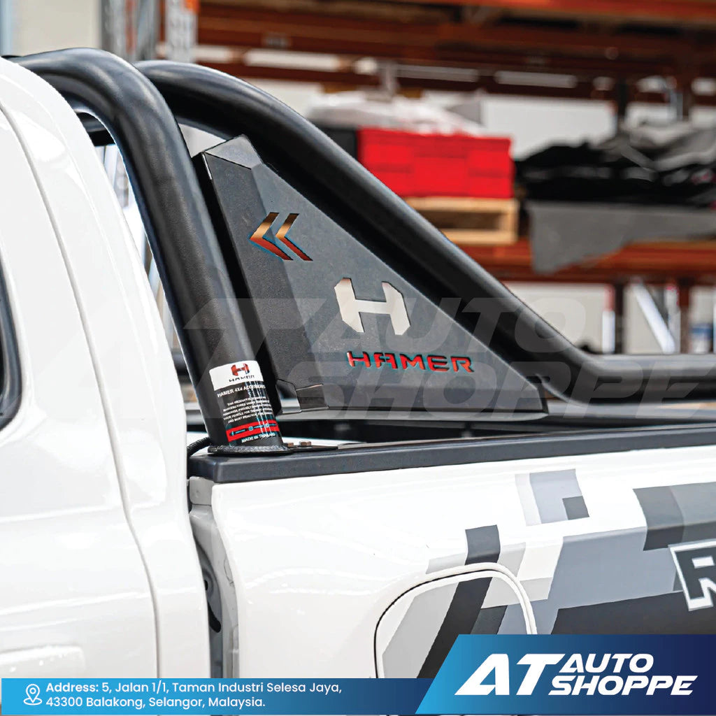 Car window with 'Hamer' branding and 'AT Auto Shoppe' logo in a garage setting.